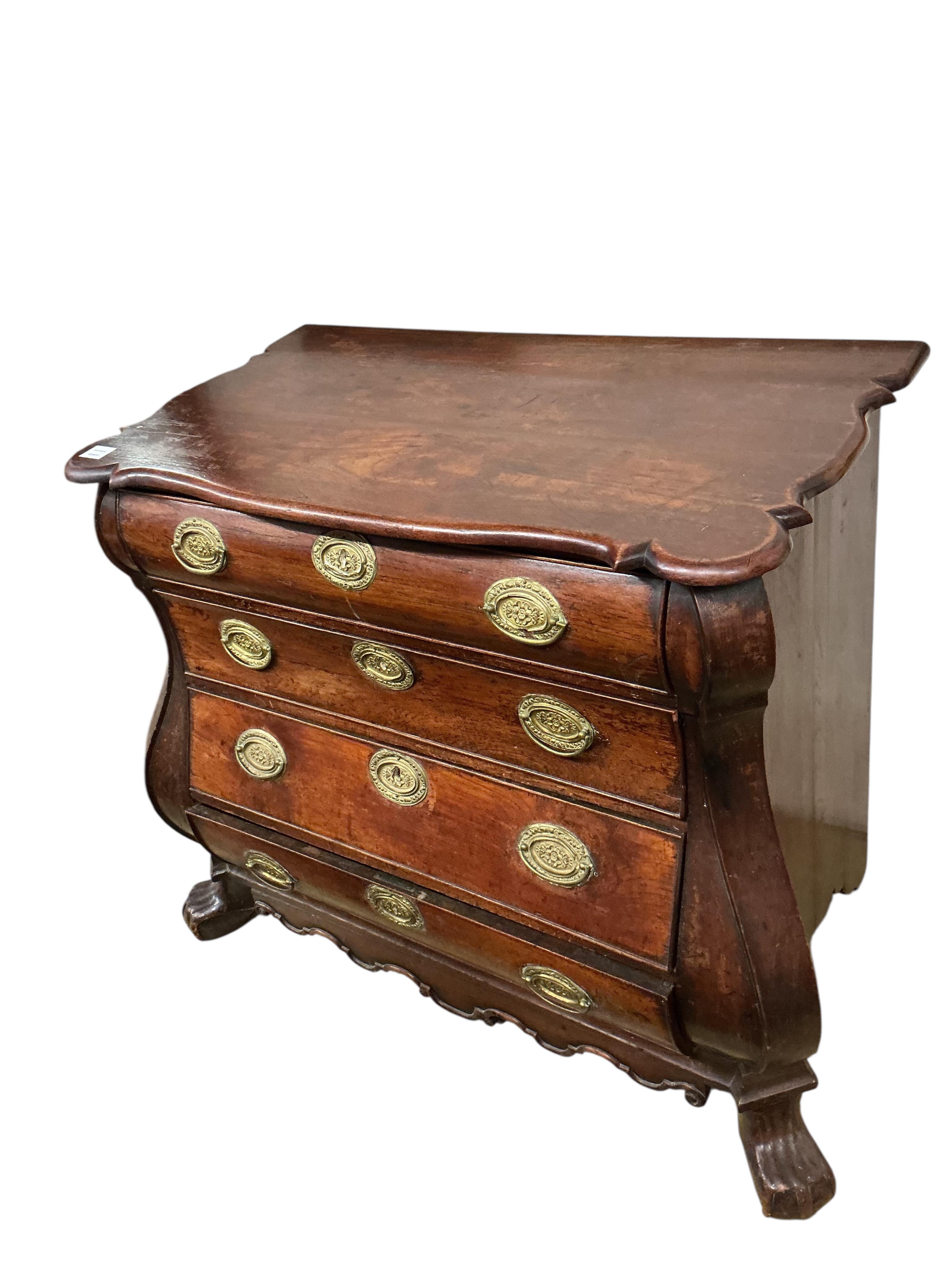 An 18th century Dutch oak bombe chest, of four long drawers, width 106cm, depth 54cm, height 87cm